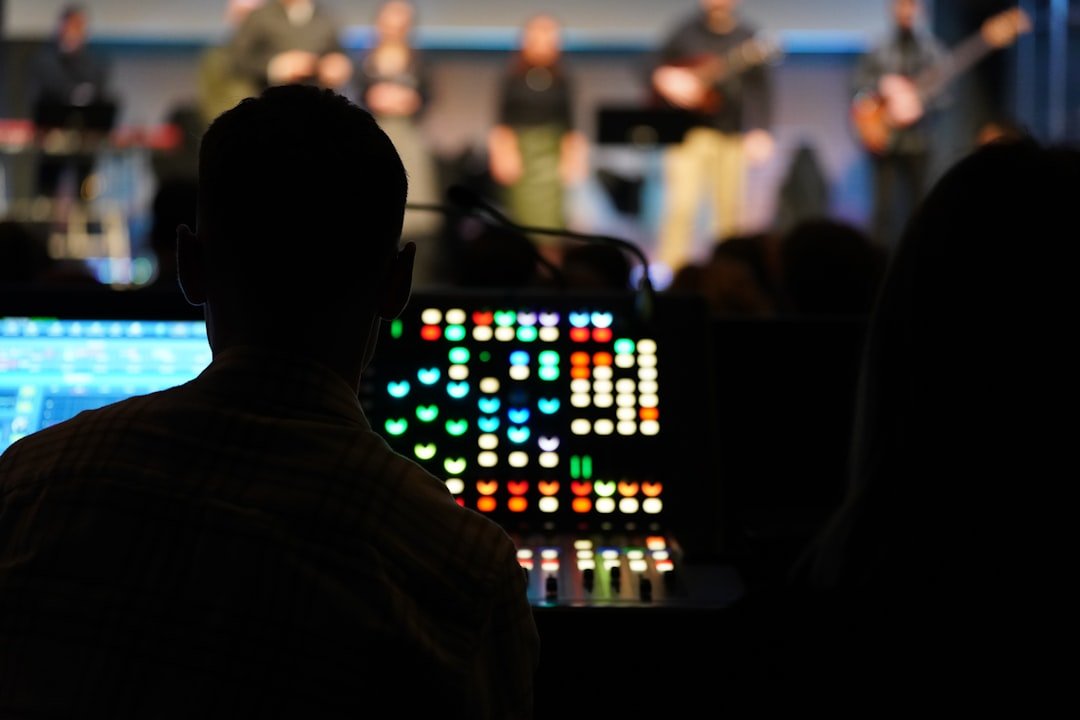 testimonial-image Sound engineer behind an audio mixer in church background.