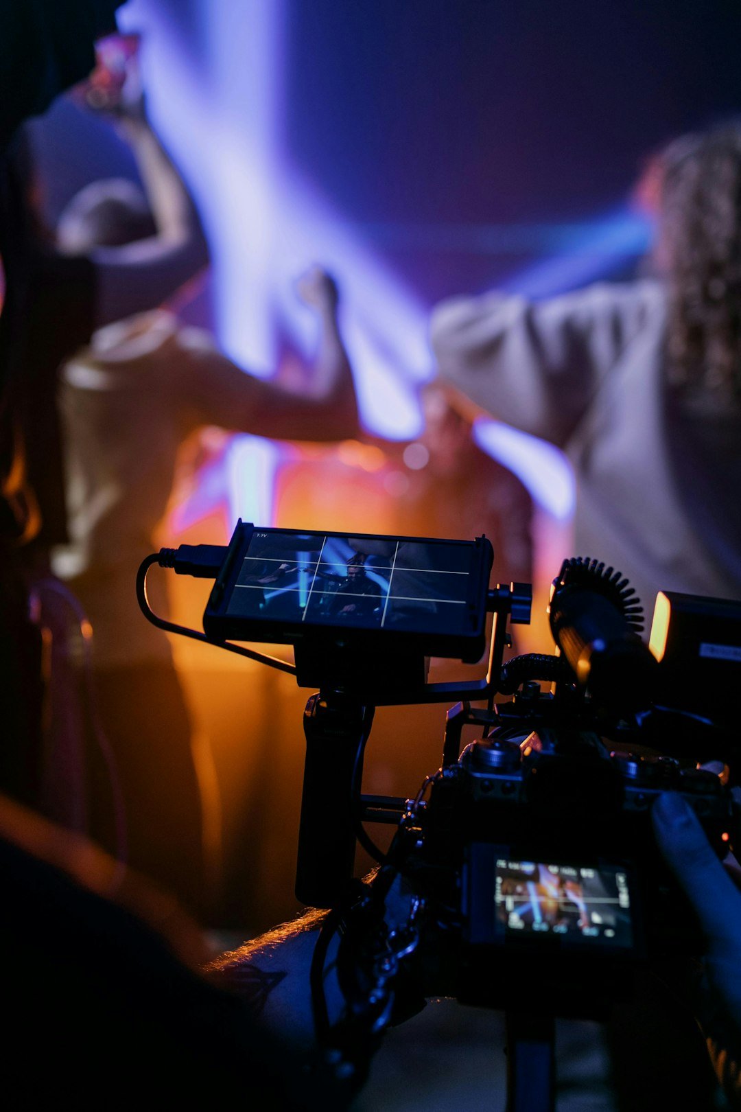 contact-img filming-a-concert-with-colorful-stage-lights-ogbe44tpabk