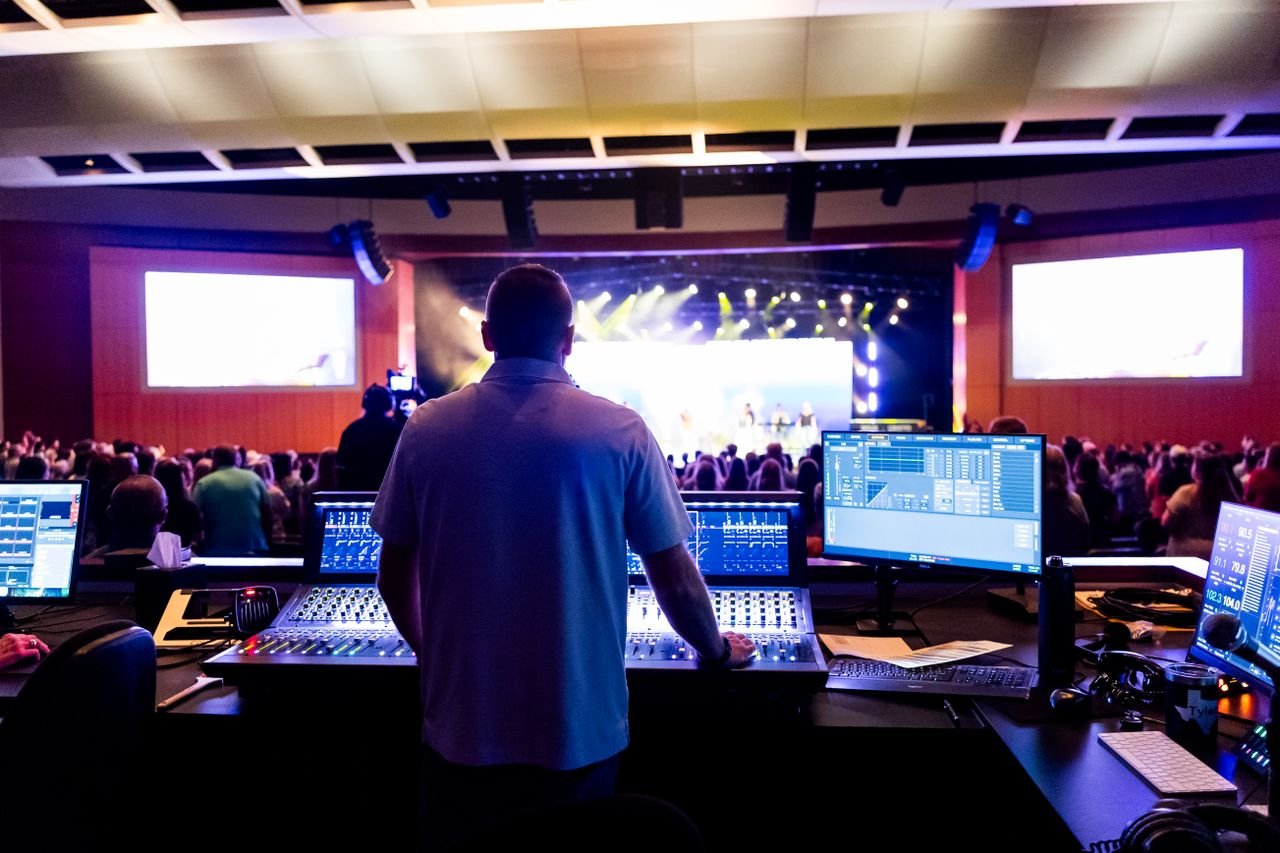 bachelor-party-01 Sound engineer managing control desk during a live music event in an indoor venue.